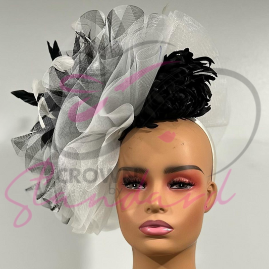 Black and white fascinator with a huge feather and a flower