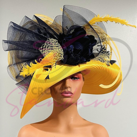 A yellow hat with navy blue crinoline, a flower, netting and other design details